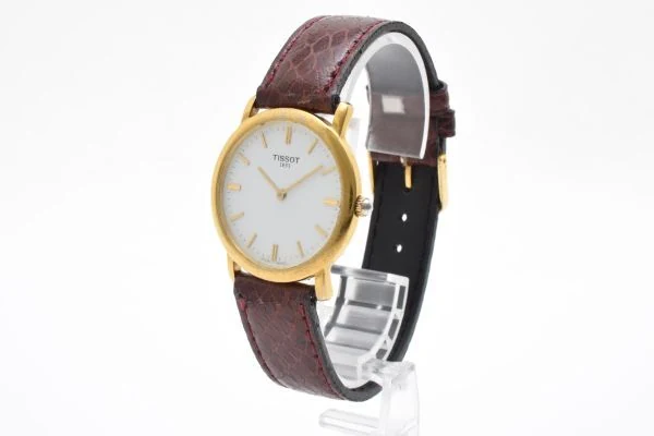 TISSOT 天梭 C276K 石英腕表正面全貌,金色表壳与白色圆形表盘
